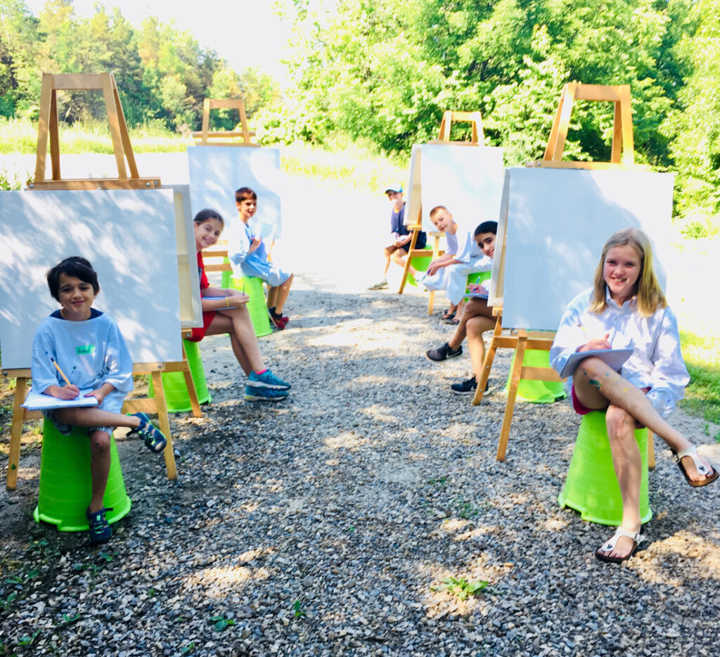 group of kids painting outdoors